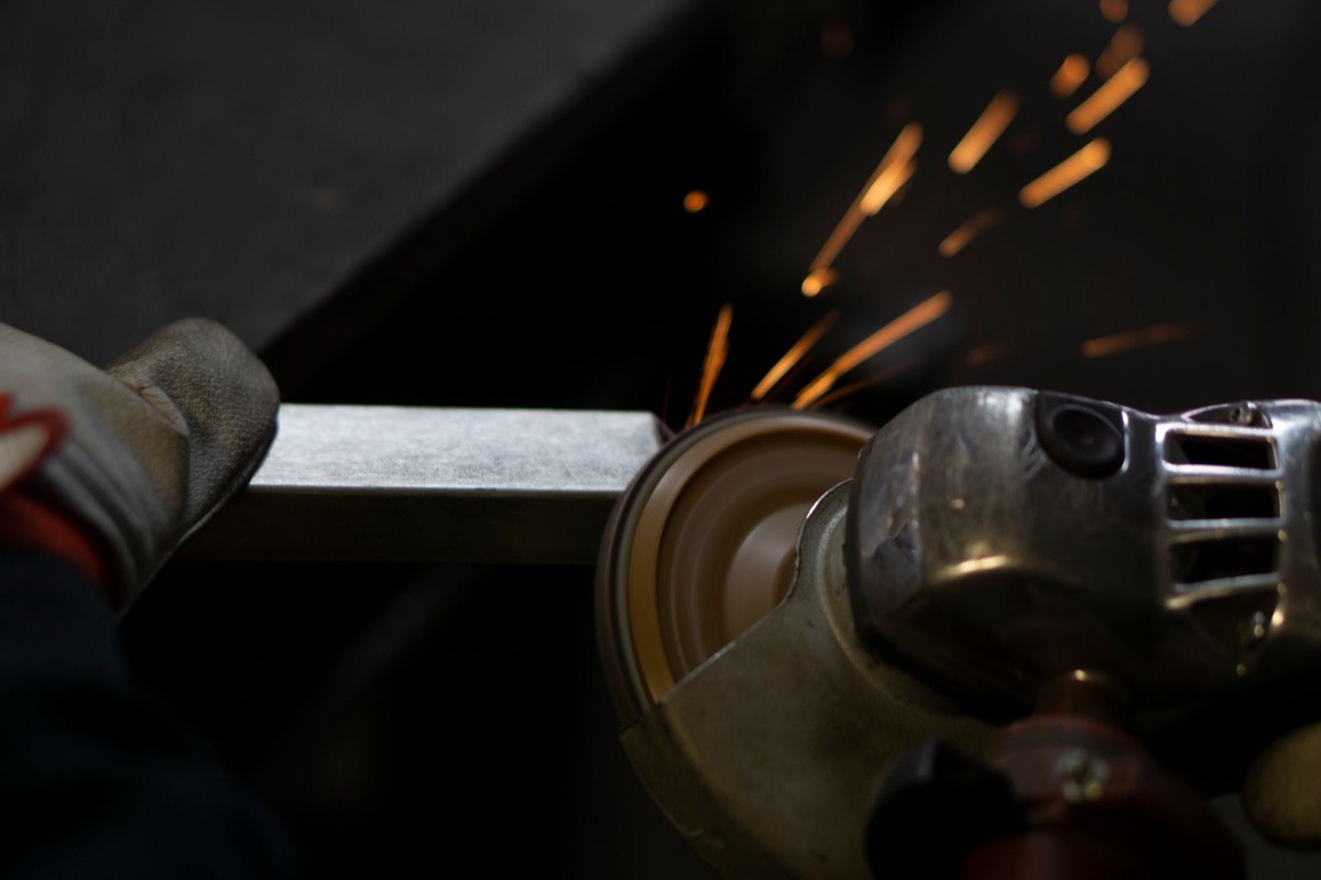 An angle grinder cutting steel, throwing off sparks