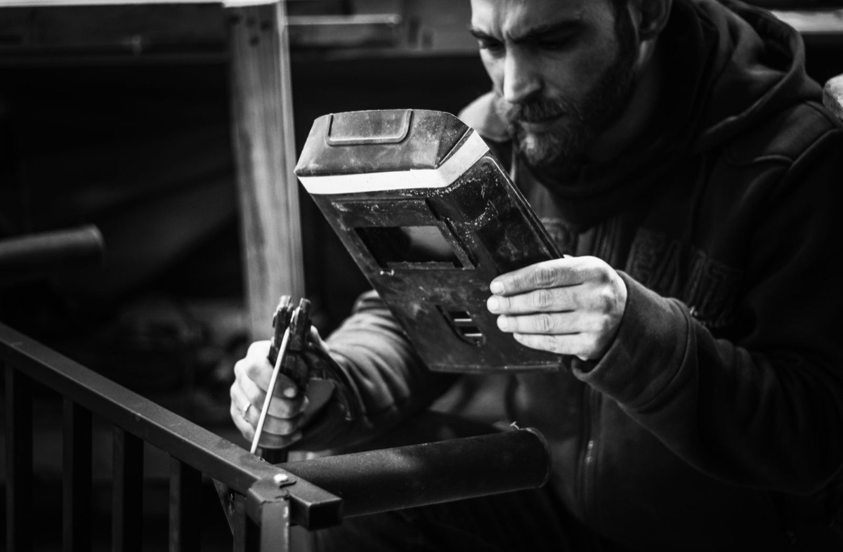 A welder examining a finished weld